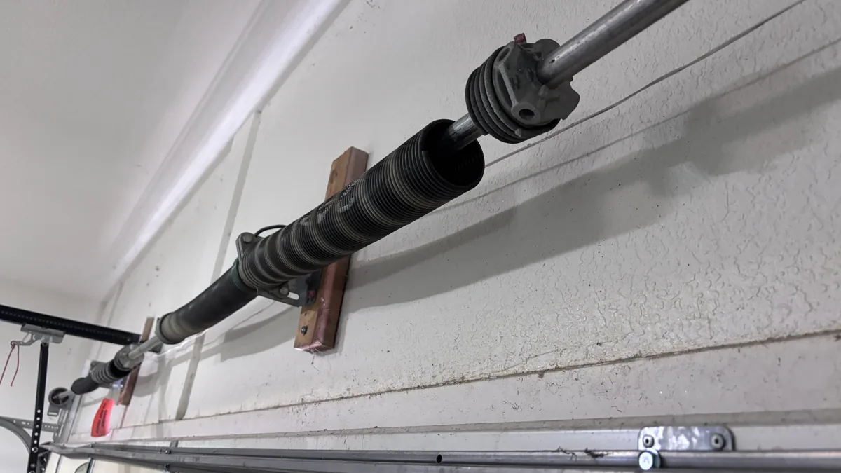 Torsion spring mounted above an Austin garage door — Edge Garage Doors spring repair
