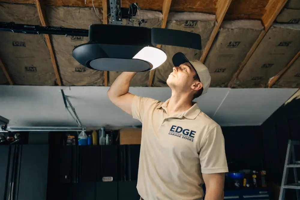 Edge Garage Doors technician repairing a garage door opener